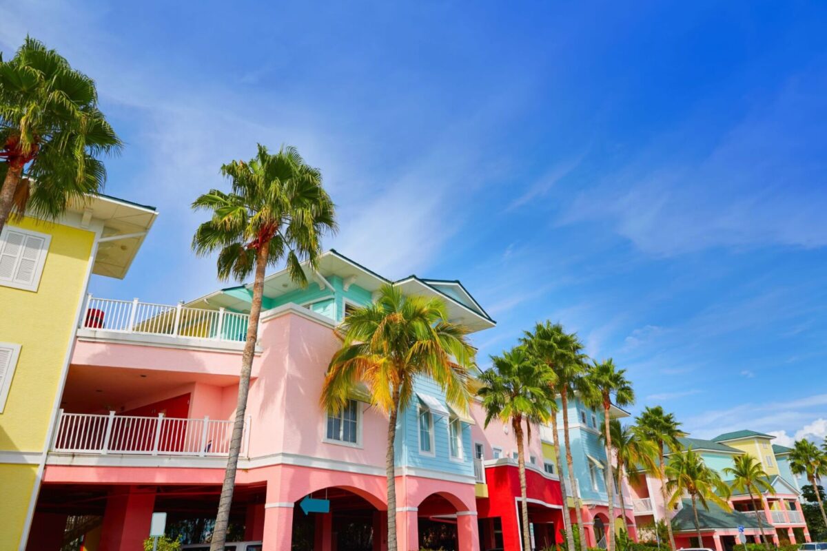 Colorful houses decorate a Fort Myers street filled with palm trees 