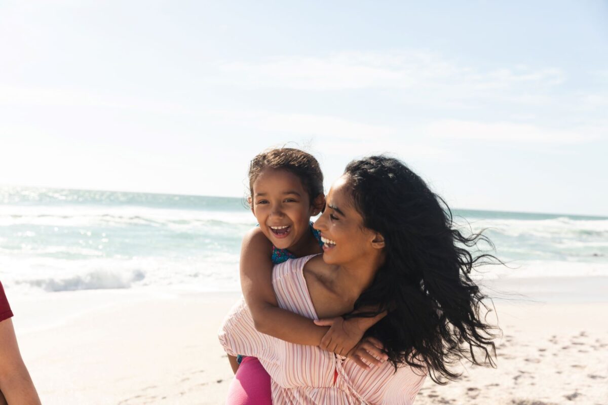 om and daughter on beach