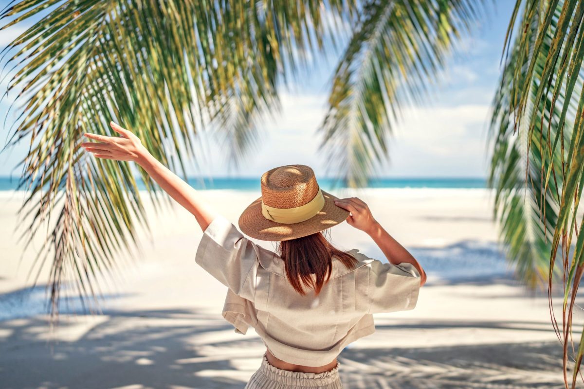 woman under palm trees in Naples Florida 